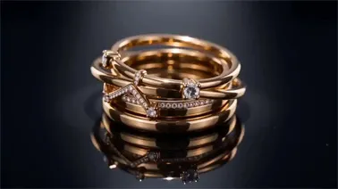 Gold Rings Luxury Macro A stack of elegant gold rings on a reflective black surface, showcasing polished textures and cinematic depth in Seedance 2.0.