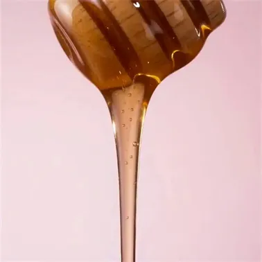 Honey Lip Mask Macro Extreme macro of golden honey dripping over a luxury lip mask jar, featuring warm amber lighting and glossy highlights in Seedance 2.0.